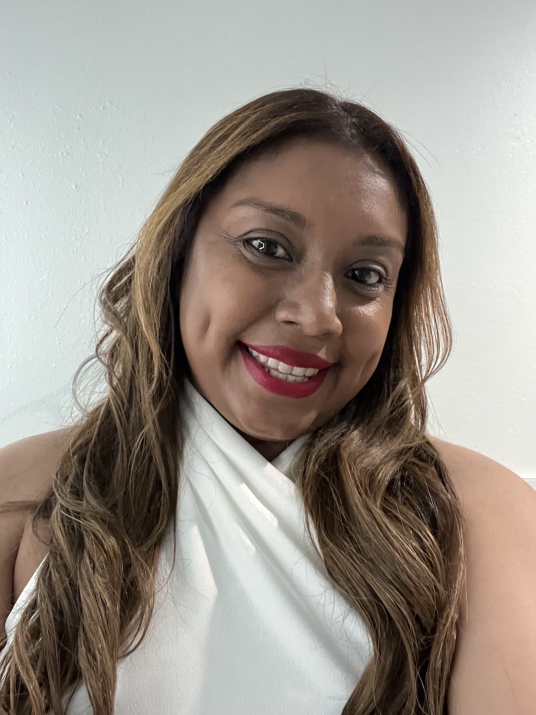 Nina Buruca-Nation smiling in a white blouse