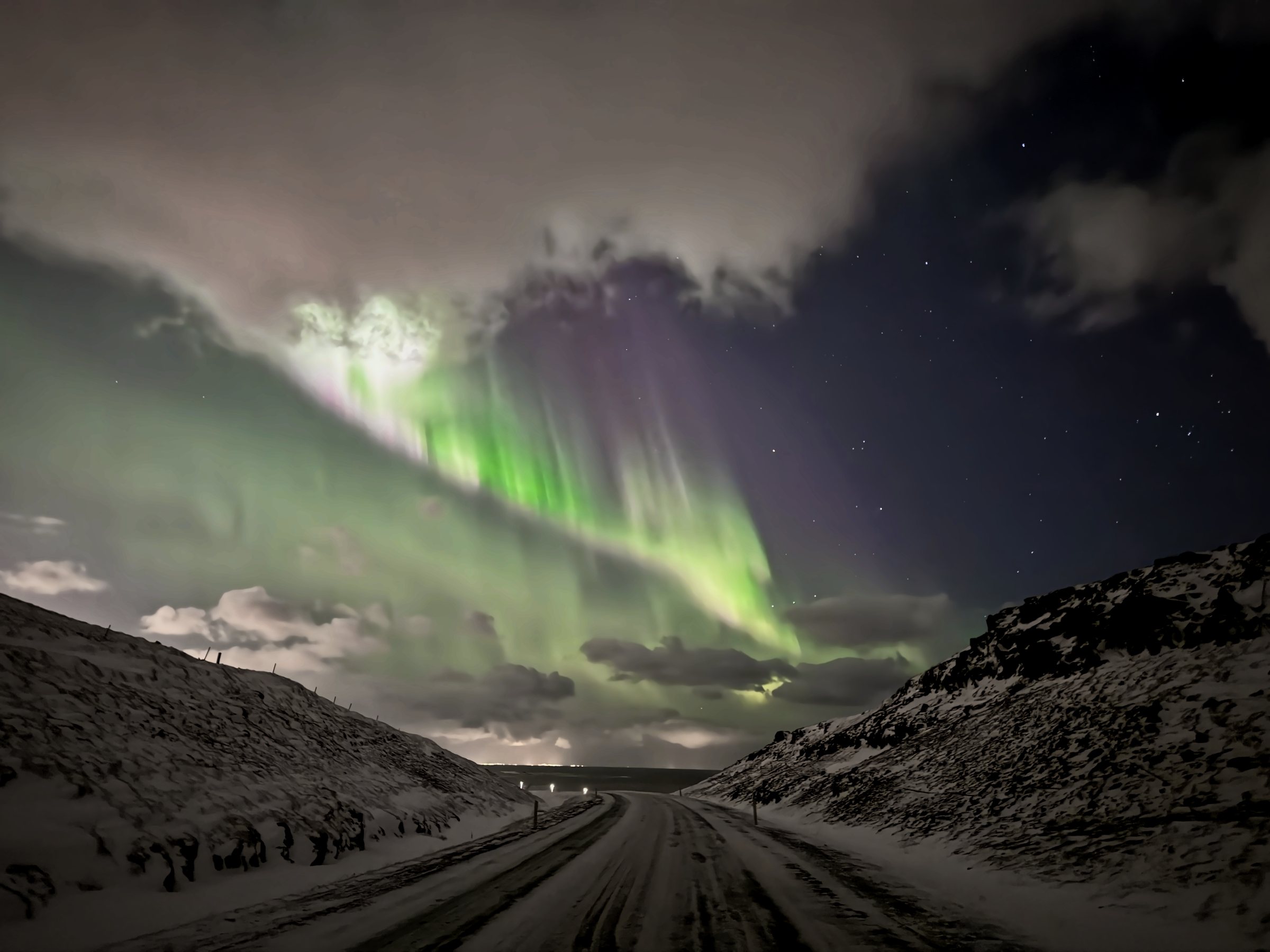 Aurora above a snowy road in Iceland