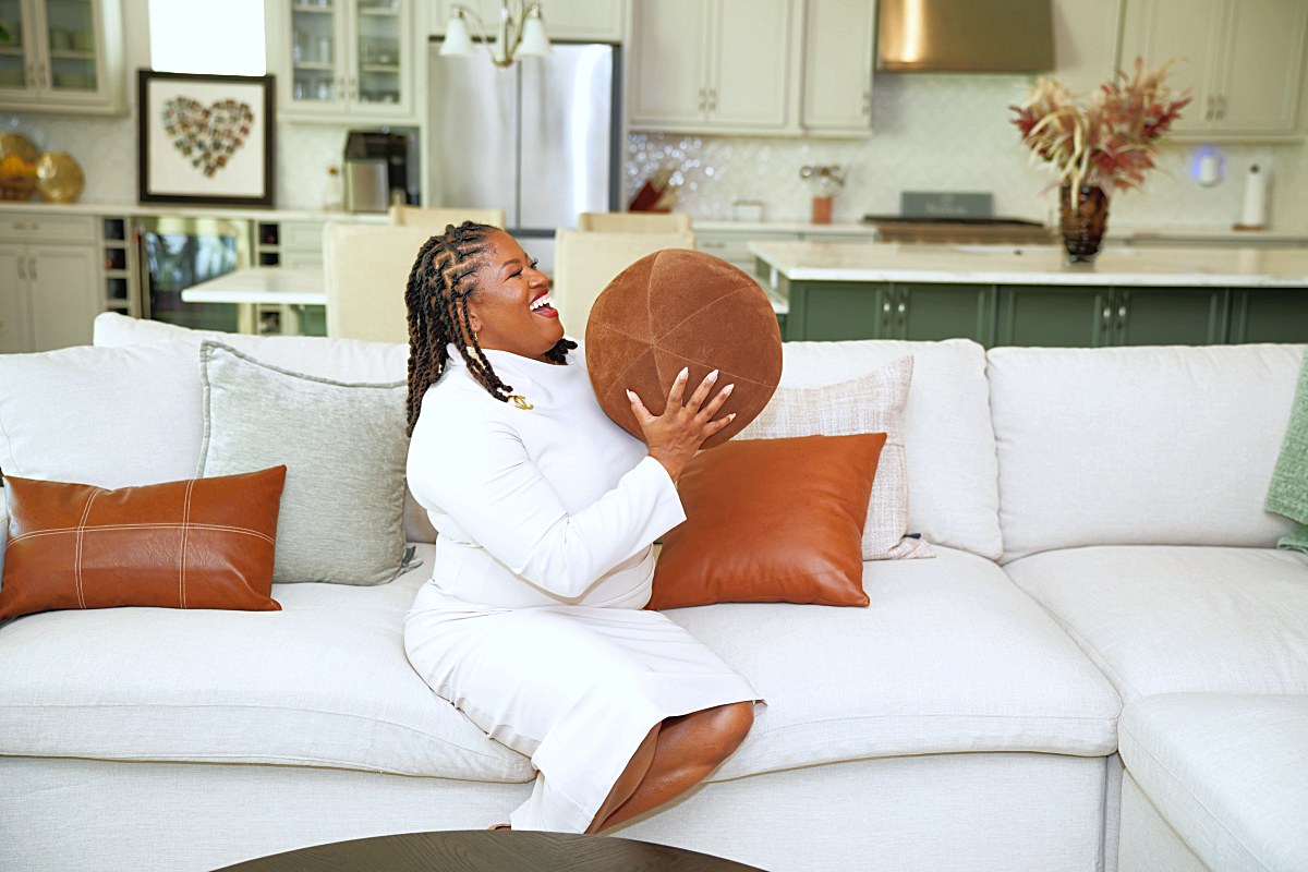 Laughing while catching a leather ball on the sectional